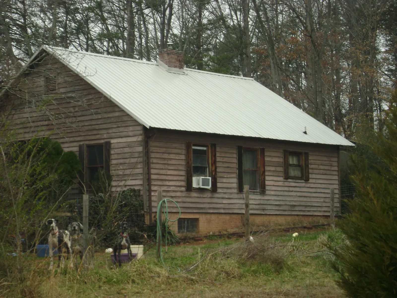 White metal roof on an old wood sided farmhouse, from a Metal Roof Installation job in Spottsville